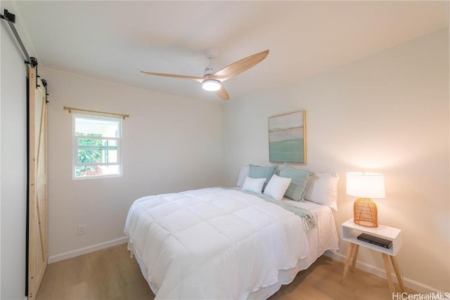 bedroom with light wood-type flooring and ceiling fan