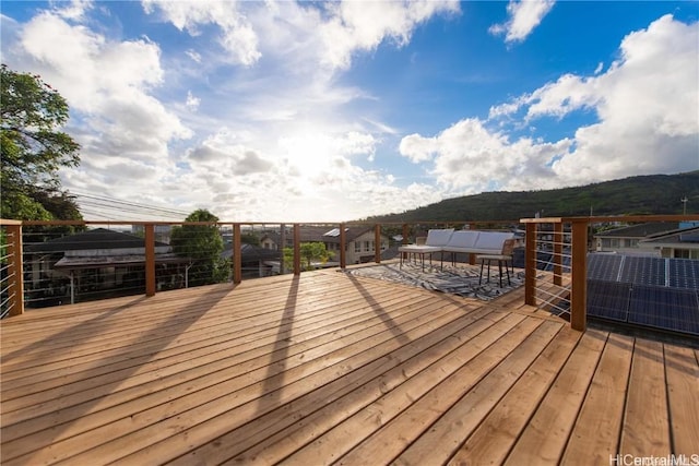 deck featuring a mountain view and an outdoor living space