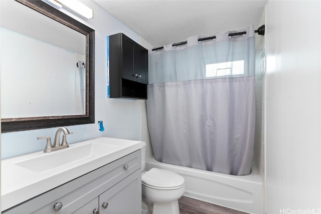 full bathroom featuring vanity, toilet, hardwood / wood-style floors, and shower / tub combo with curtain