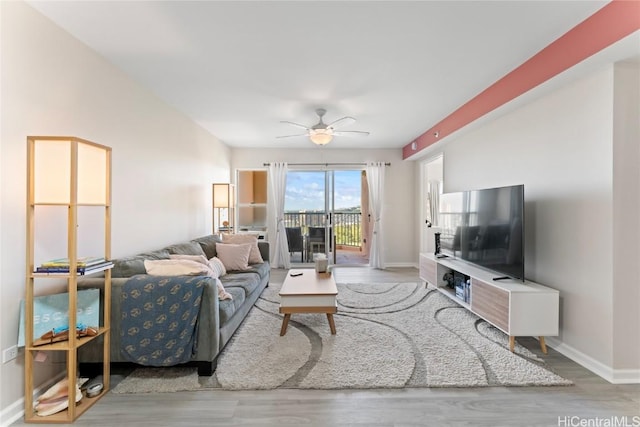 living room with ceiling fan and light hardwood / wood-style floors