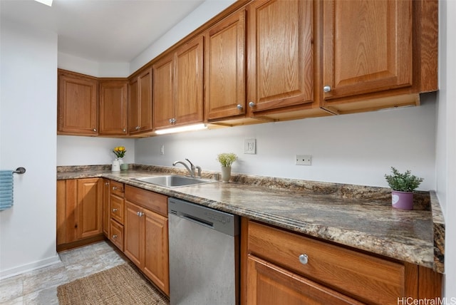 kitchen with stainless steel dishwasher, brown cabinets, and a sink