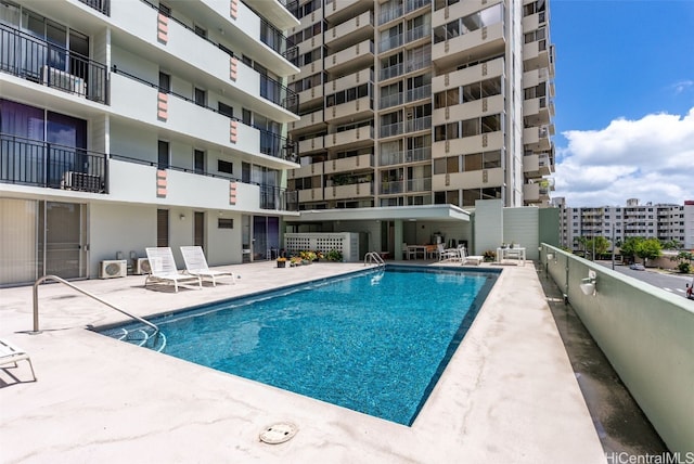 community pool featuring a view of city and a patio area