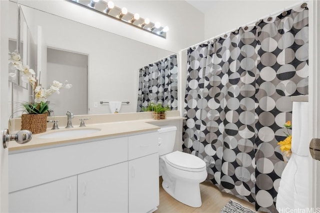 bathroom featuring hardwood / wood-style floors, vanity, and toilet