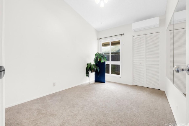 carpeted spare room with a wall mounted air conditioner and vaulted ceiling