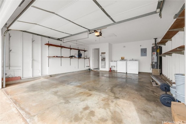 garage featuring gas water heater, sink, washing machine and dryer, electric panel, and a garage door opener