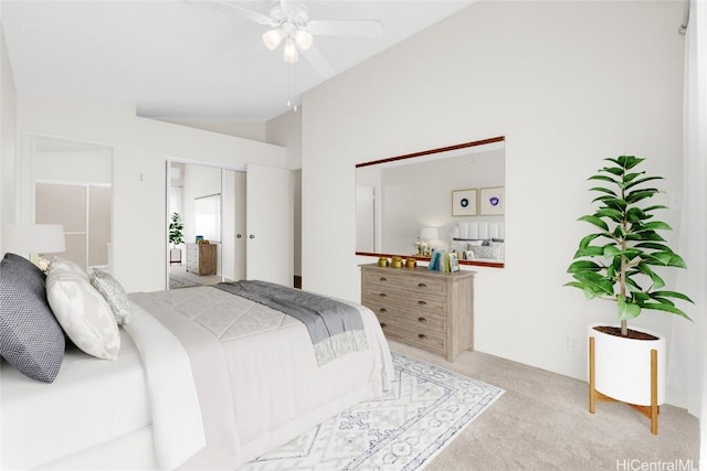 bedroom with ceiling fan, light colored carpet, and lofted ceiling