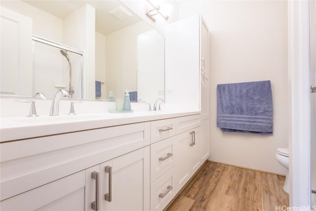 bathroom featuring hardwood / wood-style floors, vanity, and toilet