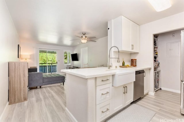 kitchen featuring white cabinets, stainless steel dishwasher, ceiling fan, and sink