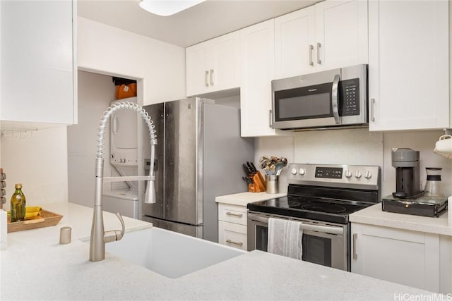 kitchen with white cabinetry and stainless steel appliances