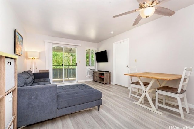 living room featuring ceiling fan, cooling unit, and light hardwood / wood-style floors