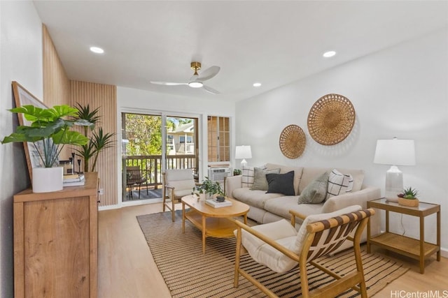 living room featuring ceiling fan and wood-type flooring