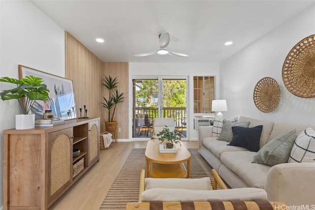 living room with light hardwood / wood-style flooring and ceiling fan