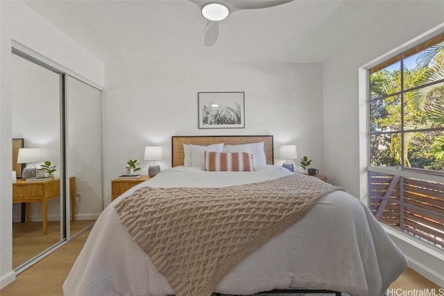 bedroom with light wood-type flooring, a closet, and ceiling fan