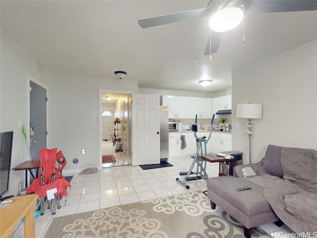 tiled living room featuring ceiling fan