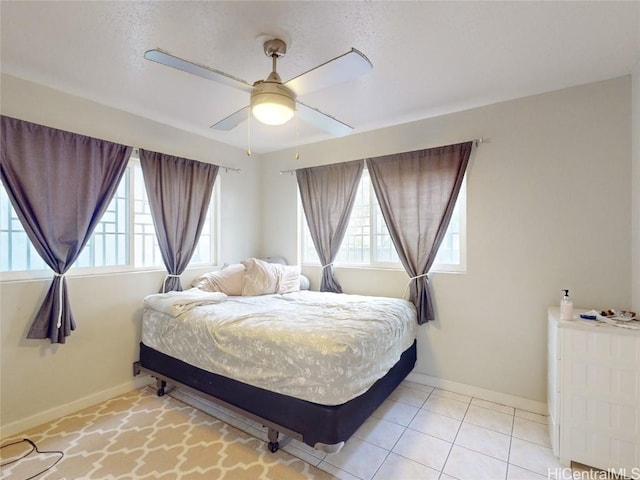 tiled bedroom with ceiling fan