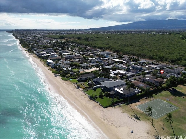 drone / aerial view with a water view and a beach view