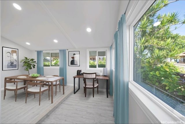 dining area featuring light wood-type flooring and lofted ceiling