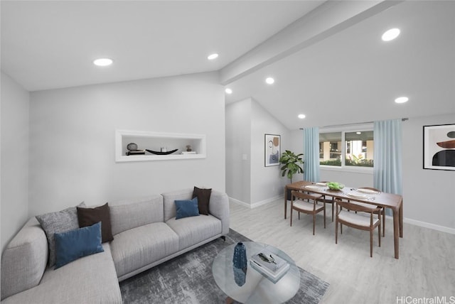 living room featuring vaulted ceiling with beams and light wood-type flooring