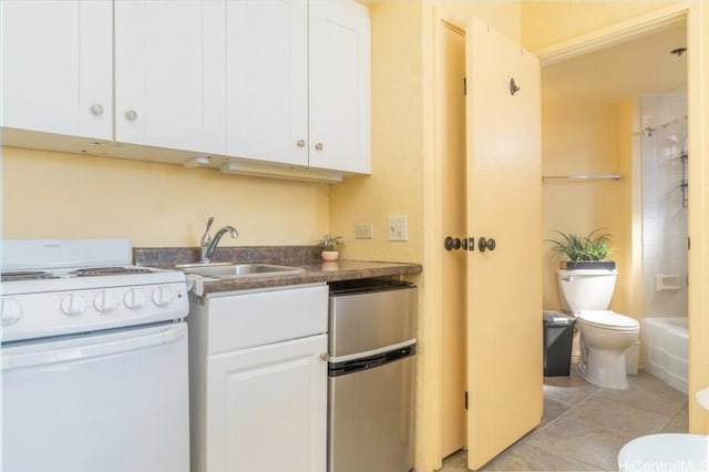 kitchen with electric stove, sink, white cabinets, and light tile patterned floors