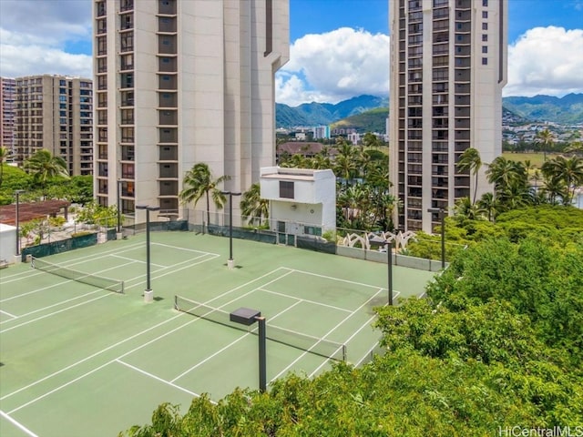 view of tennis court with a mountain view