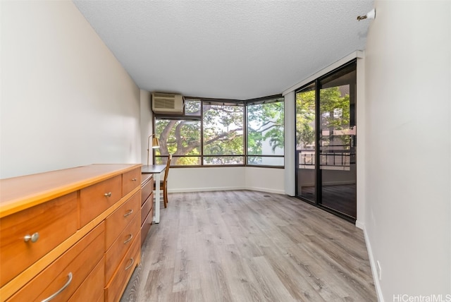 interior space with plenty of natural light and an AC wall unit