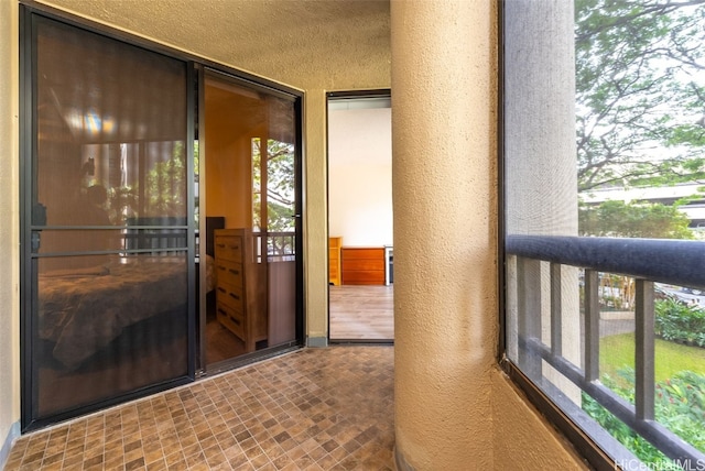 view of exterior entry with a balcony