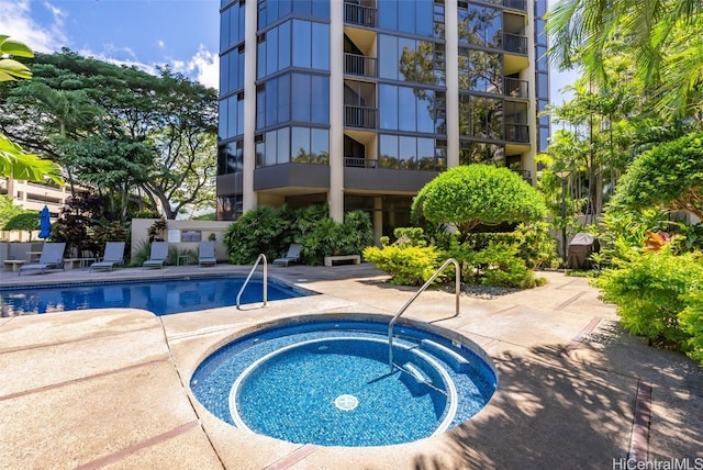 view of pool featuring a patio area and a hot tub