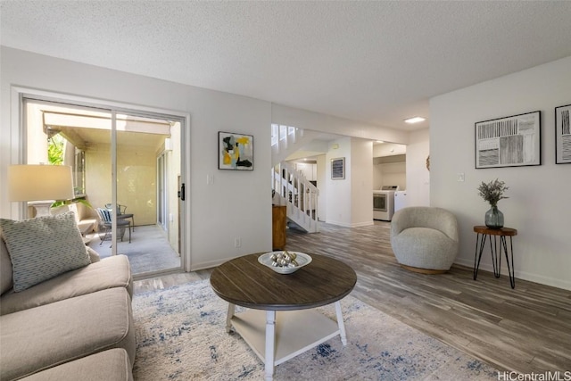 living room featuring wood-type flooring and a textured ceiling