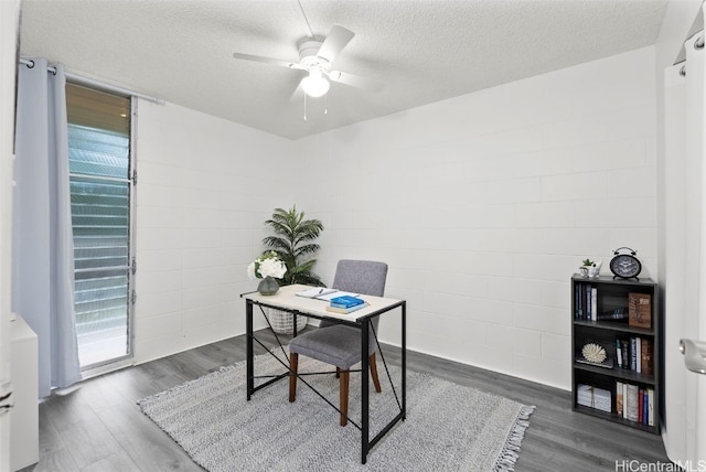 office space featuring ceiling fan, dark hardwood / wood-style floors, and a textured ceiling