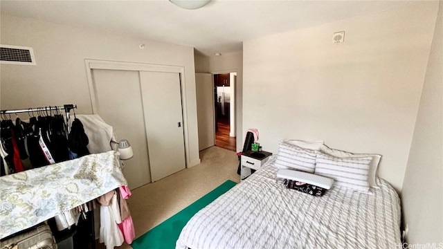 carpeted bedroom featuring a closet