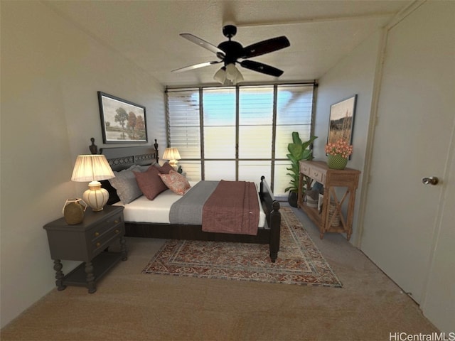 carpeted bedroom with ceiling fan and a wall of windows