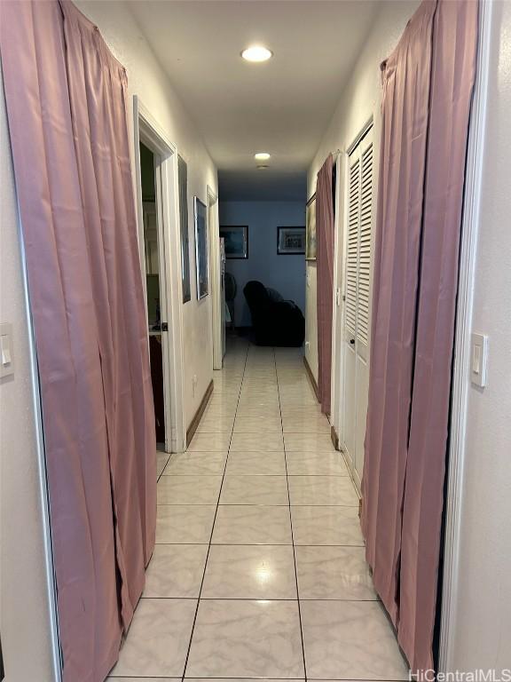 corridor featuring light tile patterned floors