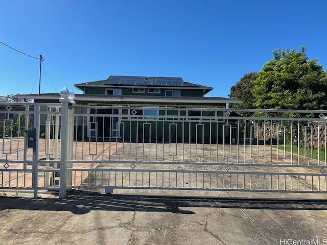 view of gate featuring solar panels