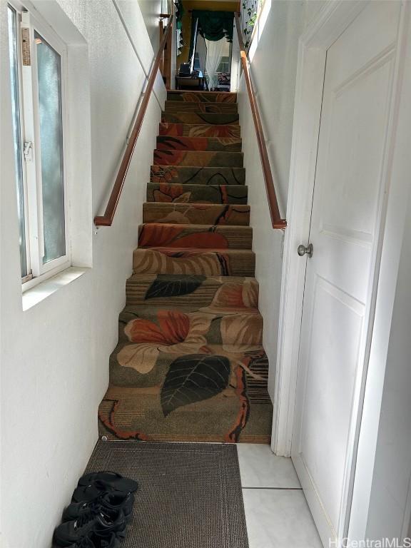 stairs featuring tile patterned flooring