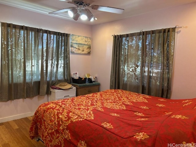 bedroom with ceiling fan and wood-type flooring