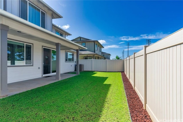 view of yard featuring a patio and central AC