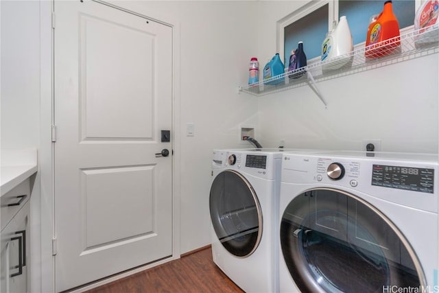 washroom with dark hardwood / wood-style flooring and washer and clothes dryer