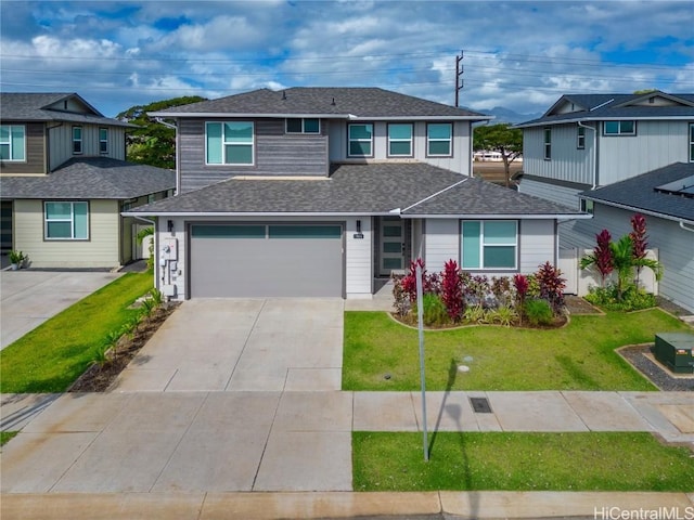 view of front of property featuring a garage and a front yard