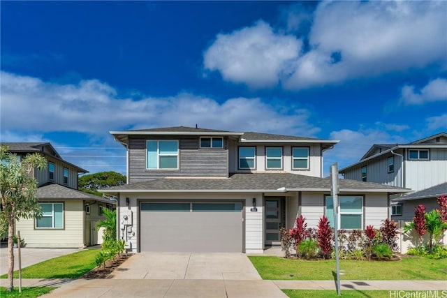 view of front facade featuring a front yard and a garage