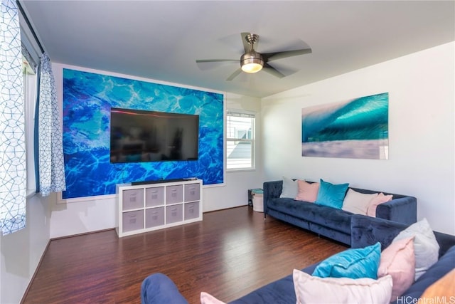 living room featuring ceiling fan and dark wood-type flooring