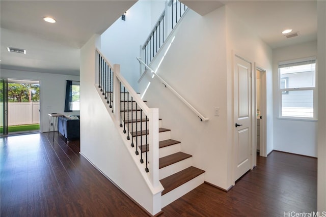 stairs featuring hardwood / wood-style floors