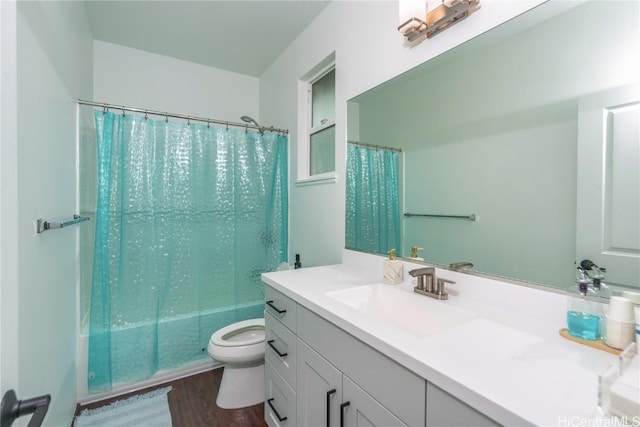 full bathroom featuring hardwood / wood-style flooring, vanity, toilet, and shower / bath combo with shower curtain