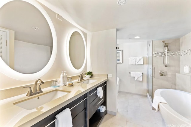 bathroom with tile patterned floors, separate shower and tub, and vanity