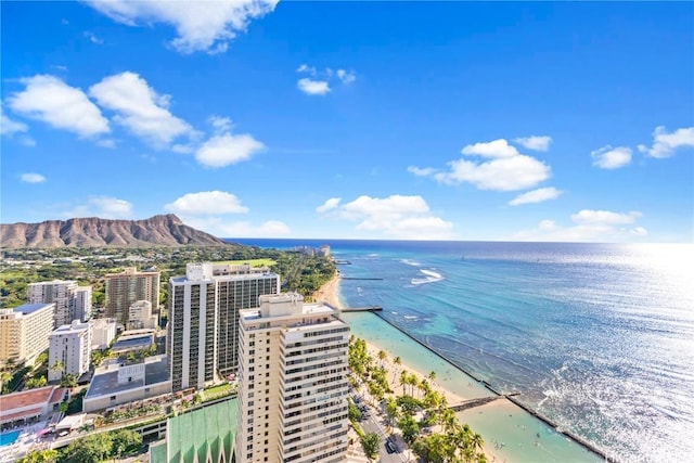 birds eye view of property with a water and mountain view and a view of the beach