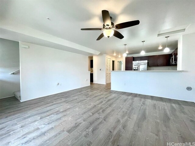 unfurnished living room featuring ceiling fan and light wood-type flooring