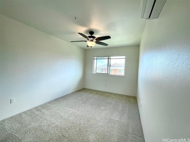 spare room with carpet flooring, ceiling fan, and a wall mounted AC