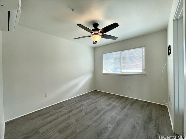 empty room featuring ceiling fan and dark hardwood / wood-style flooring