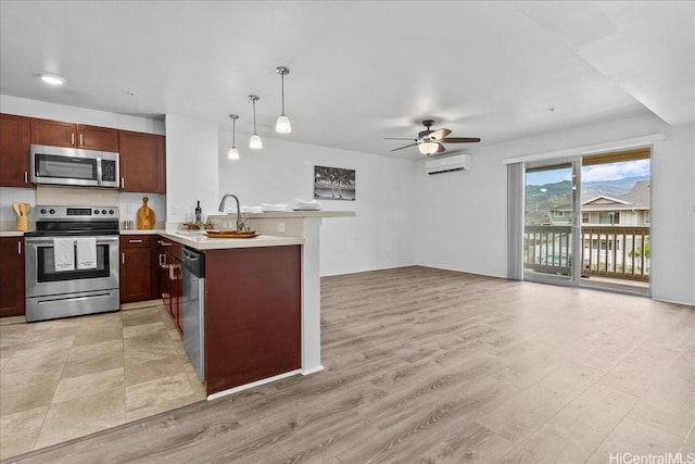 91-1081 Iwikuamoo St Unit 1203, Ewa Beach, HI 96706 - kitchen featuring appliances with stainless steel finishes, an AC wall unit, a peninsula, a ceiling fan, and light countertops