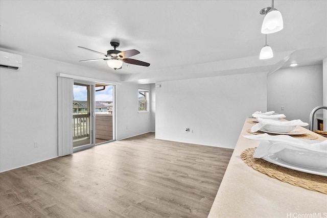 91-1081 Iwikuamoo St Unit 1203, Ewa Beach, HI 96706 - living area with ceiling fan, an AC wall unit, and wood finished floors