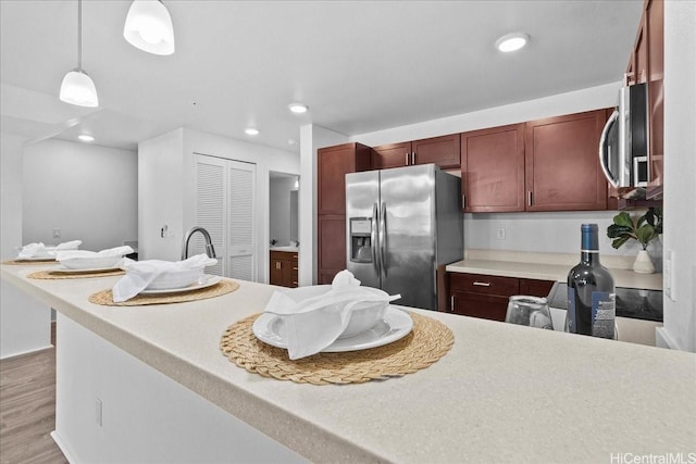 91-1081 Iwikuamoo St Unit 1203, Ewa Beach, HI 96706 - kitchen with stainless steel appliances, pendant lighting, light wood-type flooring, light countertops, and recessed lighting